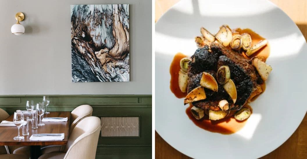 A modern dining setting featuring abstract wall art and a plated meat dish with vegetables.